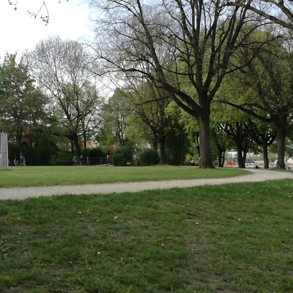 Green grass, trees, path, and a few people.